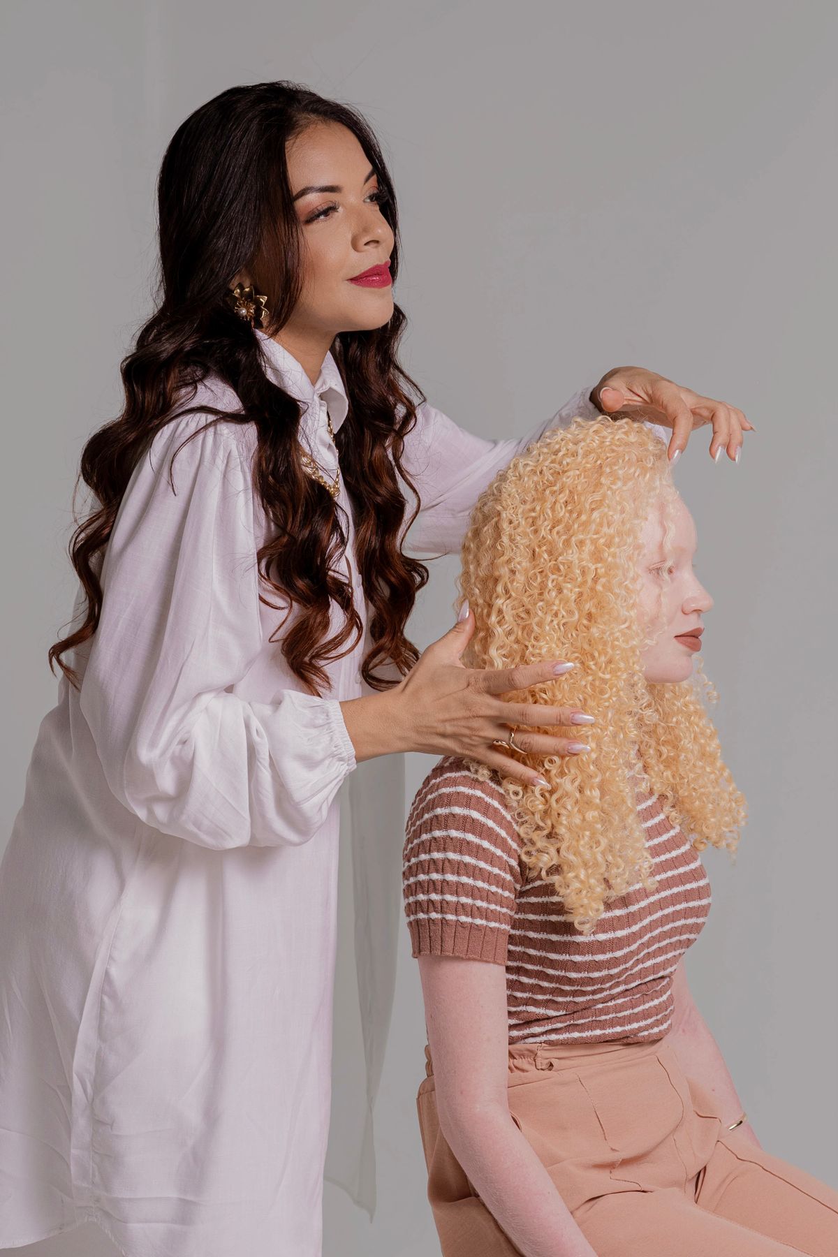 Stylist arranging a client’s curly hair
